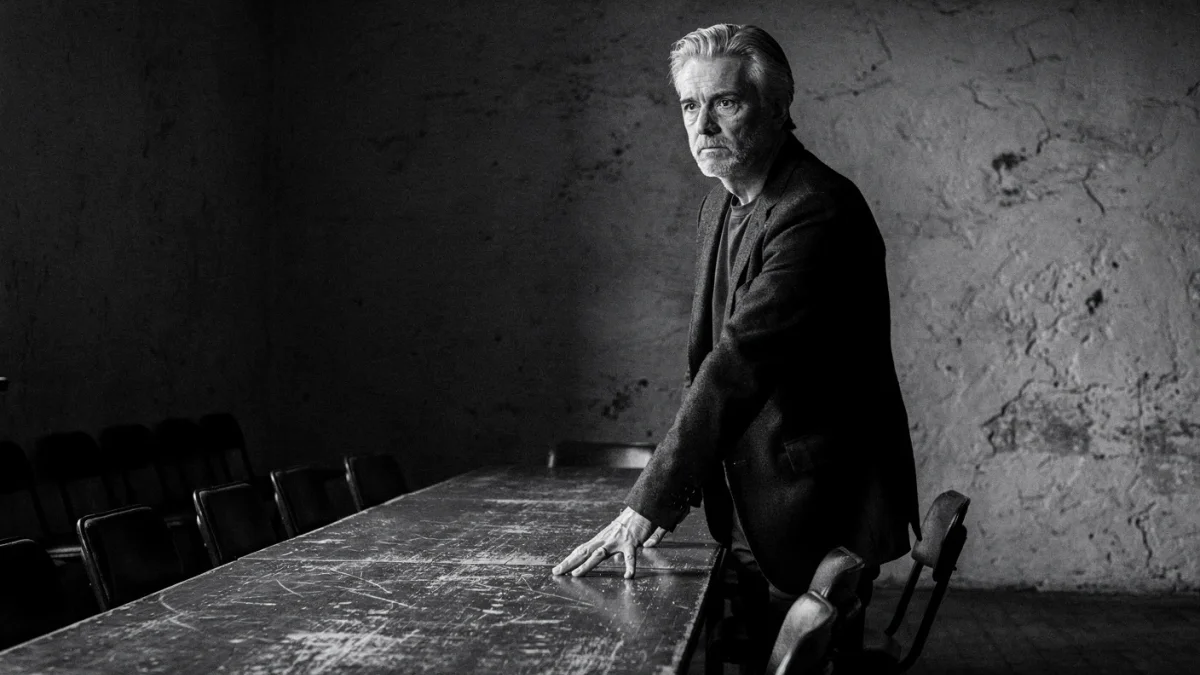 Man with grounded posture confidence credibility in meeting room