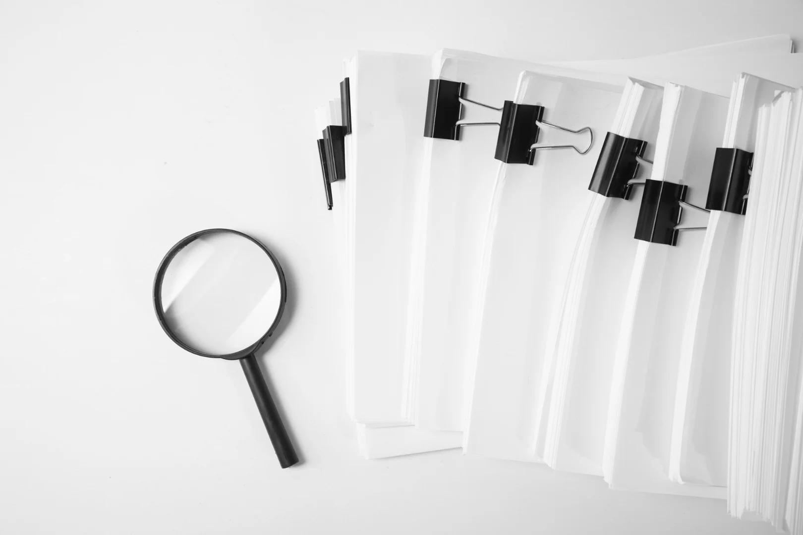 A magnifying glass revealing clear, simple terms within a complex and opaque legal contract, symbolizing the need for transparency in publishing.