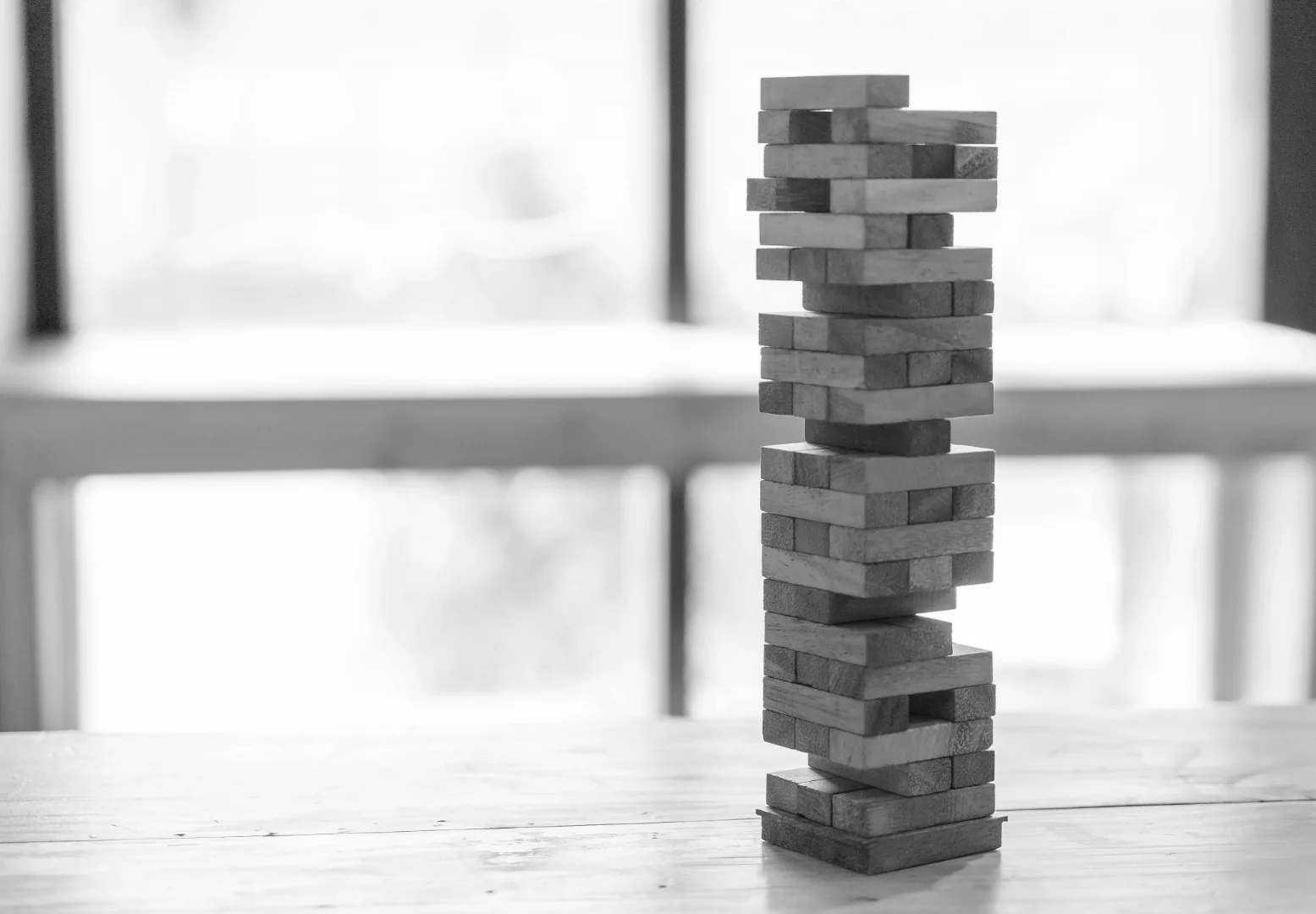 A large, impressive building revealed to be a fragile and unstable structure, representing the illusion of scale in modern media companies.